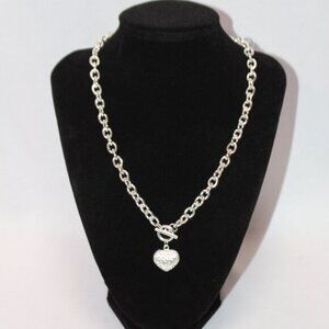 NWOT Silver Puffed Heart with Rhinestones and Closure in the front.